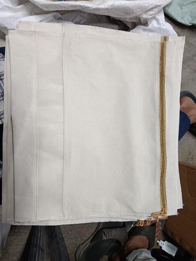 Beige fabric with gold trim on a white background