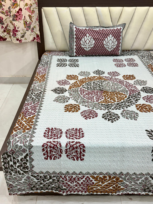 Decorative bedspread with floral patterns on a bed