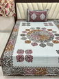 Decorative bedspread with floral patterns on a bed